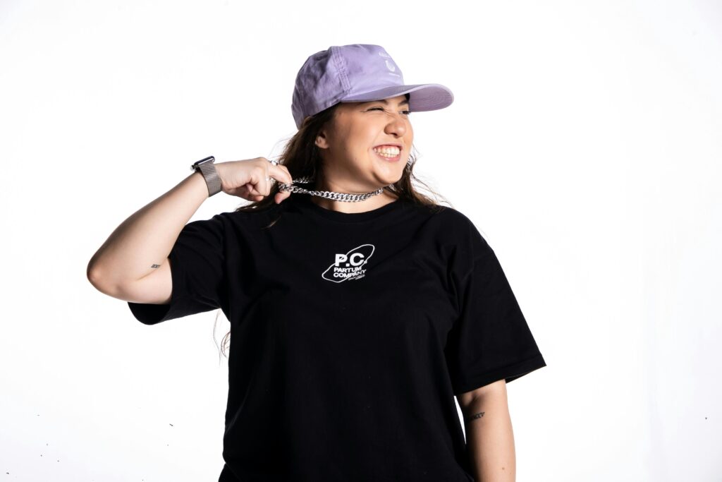 Fashion model posing with urban streetwear style and accessories.